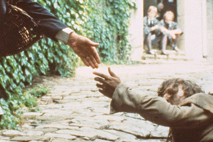 A rehearsal of the opening scene - the Bread Man (Domenic Poggi) reaching out to the Christ-like beggar (Jeffrey R. West).   From the award-winning drama, WRESTLING WITH GOD.